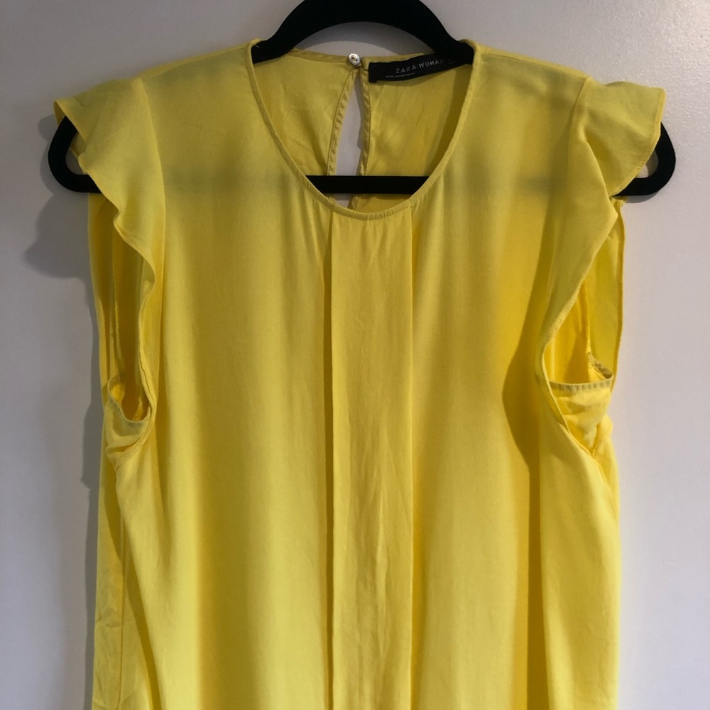 Bright yellow top with flouncy shoulders